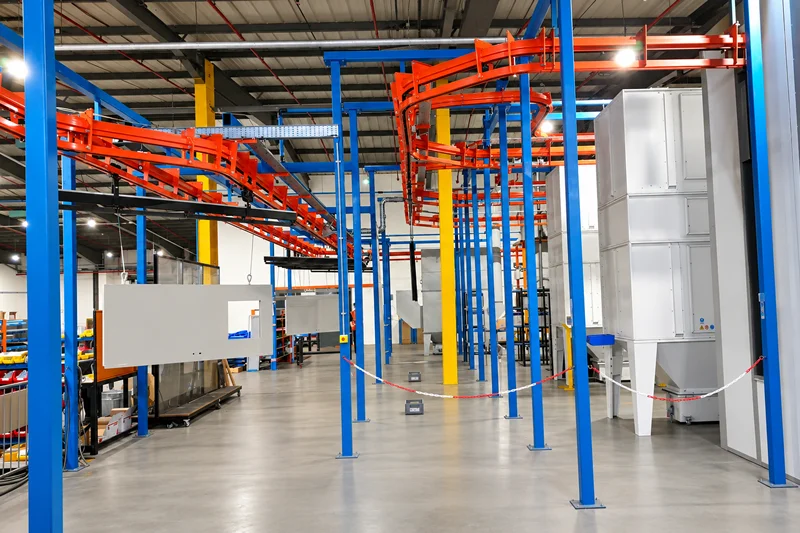 Overhead conveyor system transporting suspended door panels