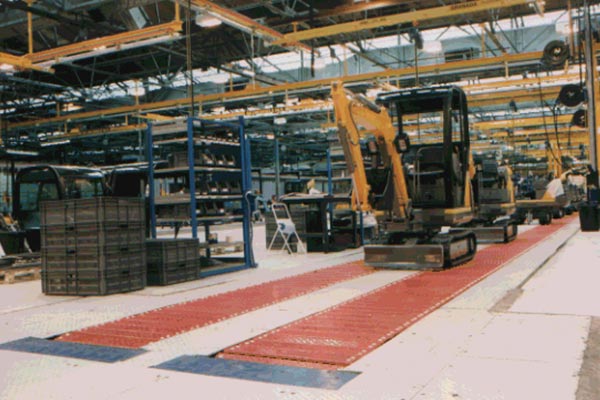 Mini Excavators on an Amber Automation HD Slat Conveyors